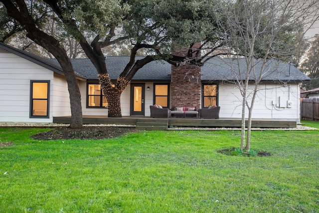 ranch-style house with an outdoor living space and a front yard