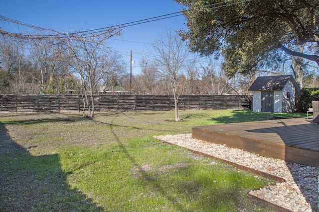 view of yard with a storage shed and a deck