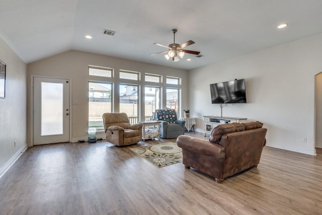 living room featuring vaulted ceiling, ceiling fan, and light hardwood / wood-style flooring