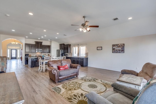 living room featuring ceiling fan, plenty of natural light, and light wood-type flooring