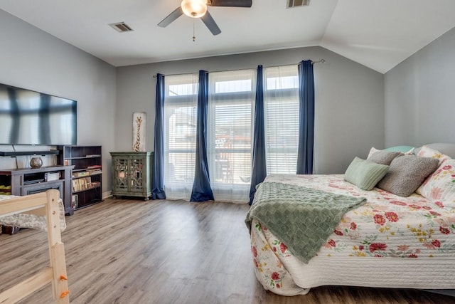 bedroom with hardwood / wood-style flooring, vaulted ceiling, and ceiling fan