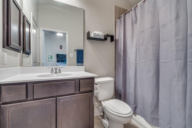 bathroom with a shower with curtain, vanity, and toilet