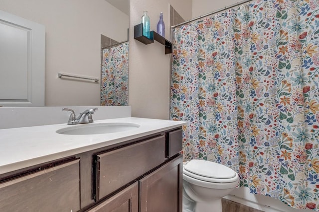 bathroom with vanity, a shower with curtain, and toilet