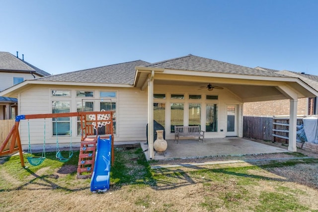 back of property featuring a playground, ceiling fan, and a patio area