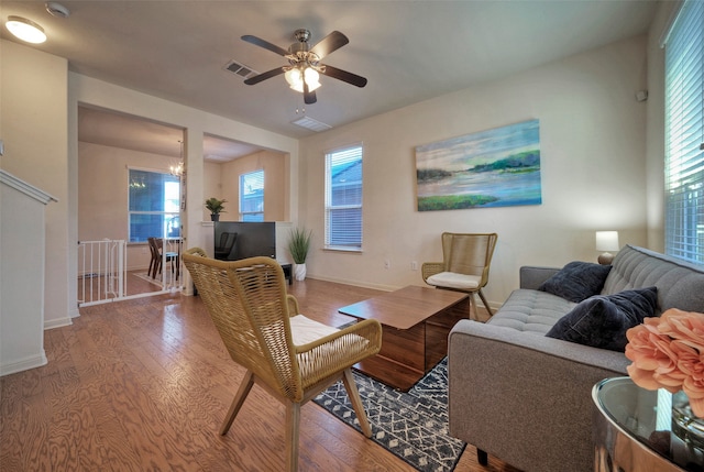 living room with hardwood / wood-style flooring and ceiling fan