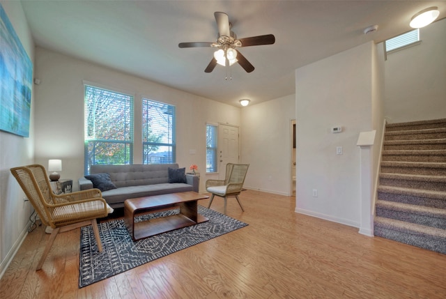 living room featuring ceiling fan and light wood-type flooring