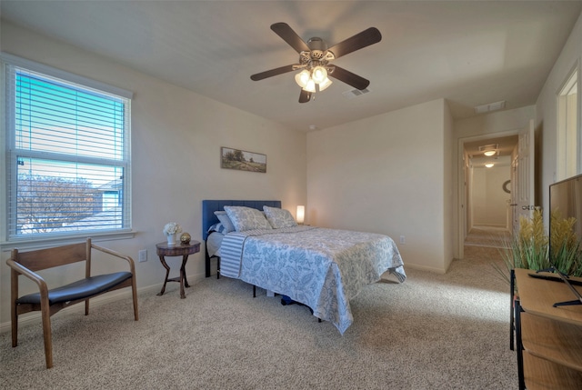 bedroom featuring light colored carpet and ceiling fan