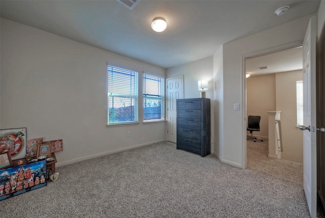 carpeted bedroom with multiple windows