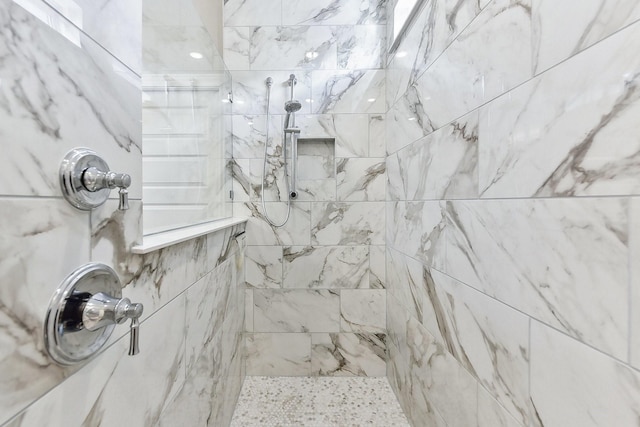 bathroom with tiled shower