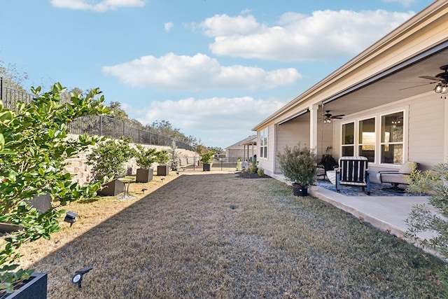 view of yard featuring a patio and ceiling fan