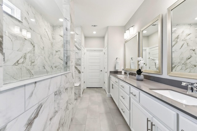 bathroom with vanity and a tile shower