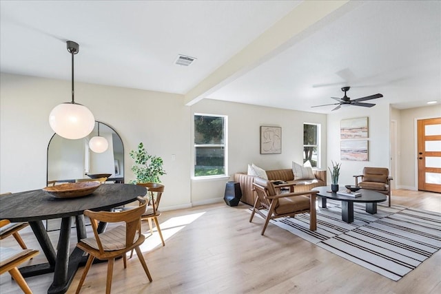 living room featuring ceiling fan, beam ceiling, and light hardwood / wood-style floors