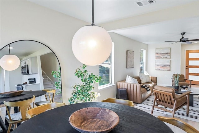 dining area with ceiling fan and hardwood / wood-style floors