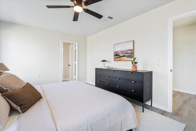 bedroom with ceiling fan and light hardwood / wood-style floors