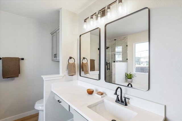 bathroom featuring hardwood / wood-style floors, vanity, toilet, and a shower with shower door