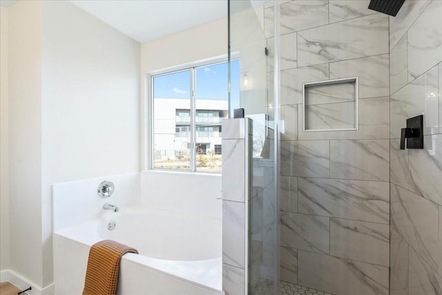 bathroom featuring plenty of natural light and shower with separate bathtub