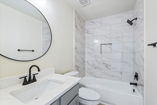 full bathroom featuring vanity, toilet, and tiled shower / bath