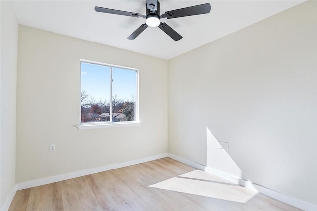 empty room with ceiling fan and light hardwood / wood-style flooring