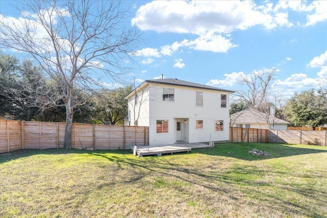 back of house featuring a yard and a deck