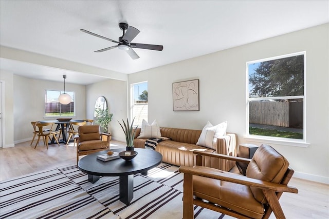 living room featuring ceiling fan and light hardwood / wood-style floors