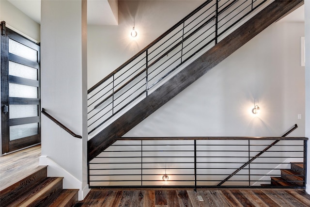 stairway featuring wood-type flooring