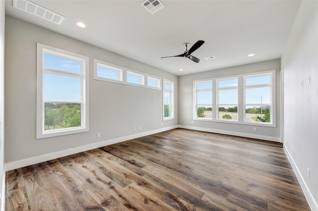 spare room with dark wood-type flooring and ceiling fan