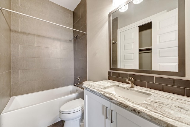 full bathroom with tasteful backsplash, vanity, toilet, and tiled shower / bath