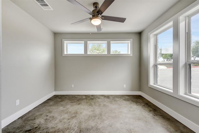 spare room featuring plenty of natural light and ceiling fan