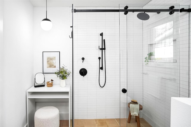 bathroom with a shower with door