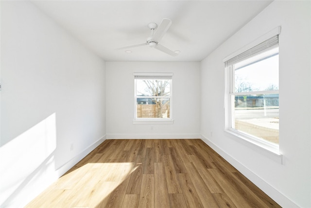 spare room with ceiling fan and hardwood / wood-style floors