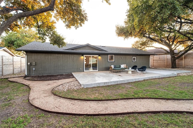 rear view of property with a patio and outdoor lounge area