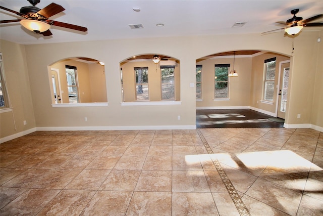 tiled spare room with ceiling fan