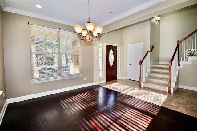 entrance foyer with crown molding, a chandelier, and hardwood / wood-style flooring