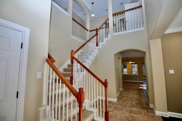 stairway with a towering ceiling