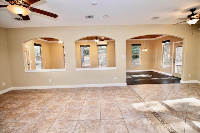 empty room with ceiling fan and ornamental molding