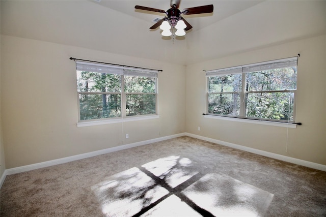 carpeted spare room with ceiling fan