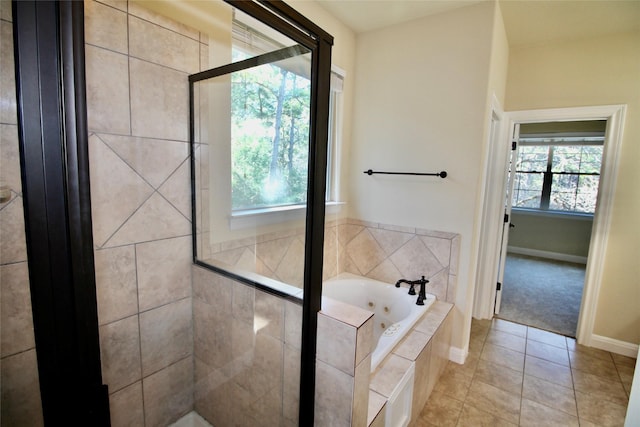 bathroom featuring tile patterned floors and separate shower and tub