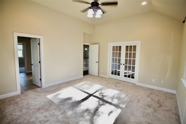 spare room featuring vaulted ceiling, light carpet, ceiling fan, and french doors