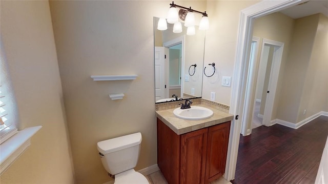 bathroom with vanity, hardwood / wood-style flooring, and toilet