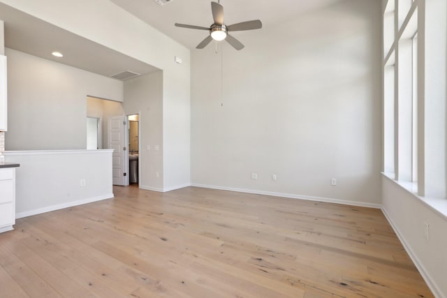 unfurnished living room with ceiling fan and light hardwood / wood-style floors