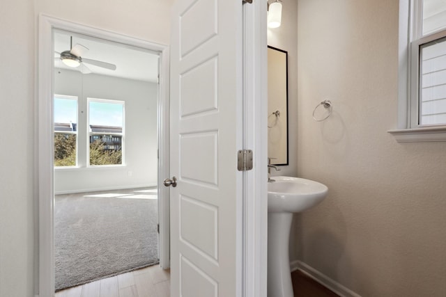 bathroom featuring ceiling fan and wood-type flooring