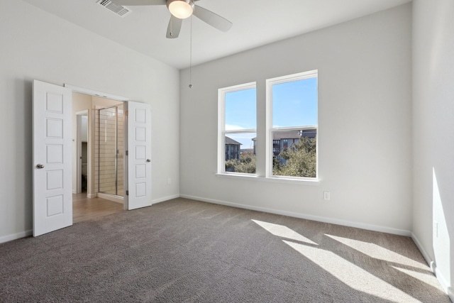 unfurnished bedroom with carpet, ceiling fan, and ensuite bath