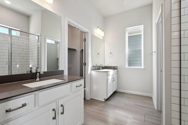 bathroom featuring vanity and an enclosed shower