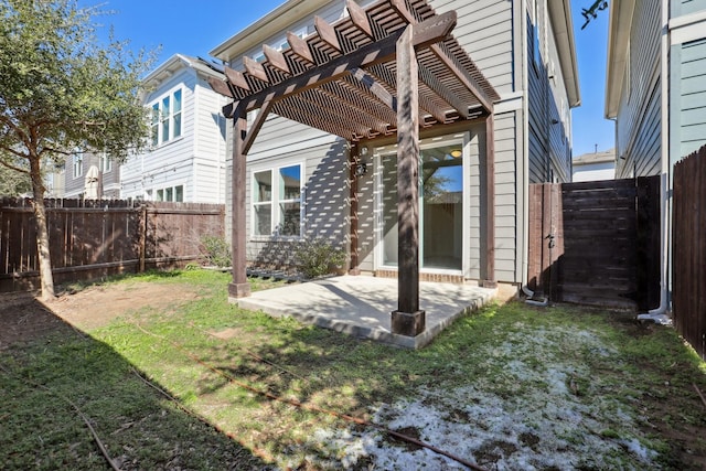 rear view of property featuring a yard, a pergola, and a patio area