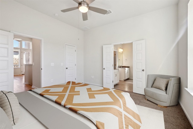 carpeted bedroom featuring connected bathroom and ceiling fan