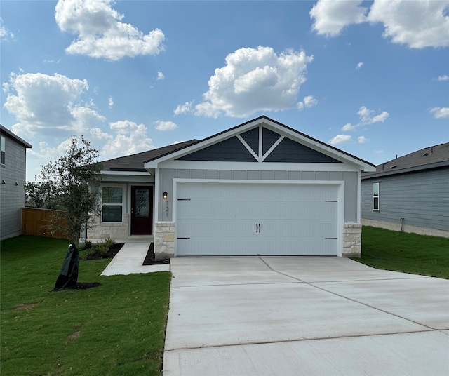 view of front of home featuring a garage and a front lawn