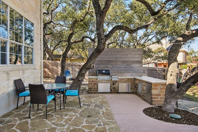 view of patio featuring area for grilling and a grill