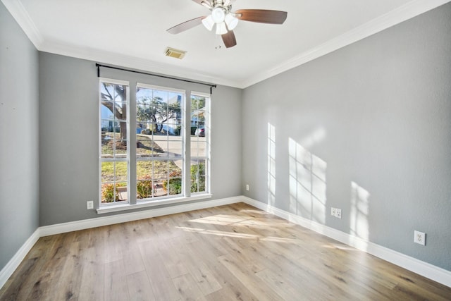 empty room with ornamental molding, ceiling fan, and light wood-type flooring