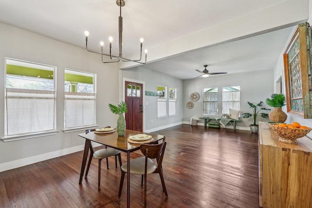 dining space with dark hardwood / wood-style flooring, ceiling fan with notable chandelier, and a wealth of natural light