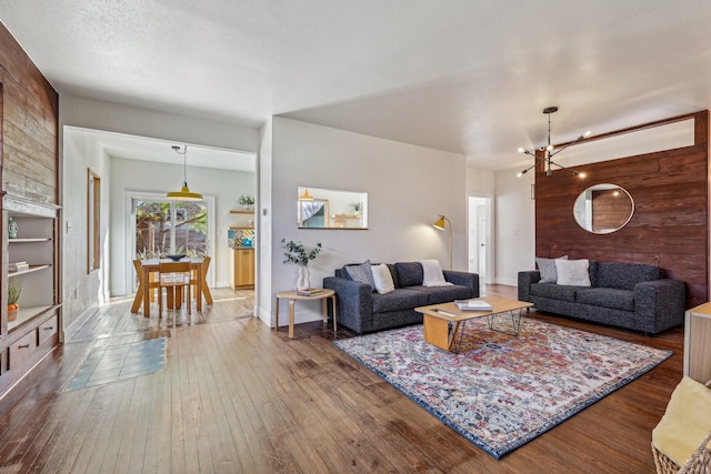 living room with hardwood / wood-style floors and a chandelier